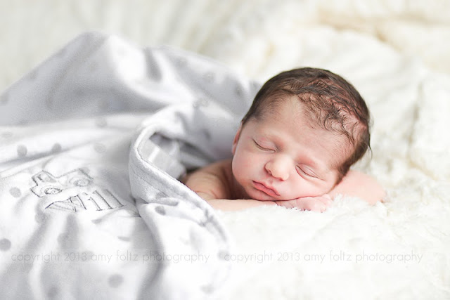 photo of newborn baby boy with personalized blanket