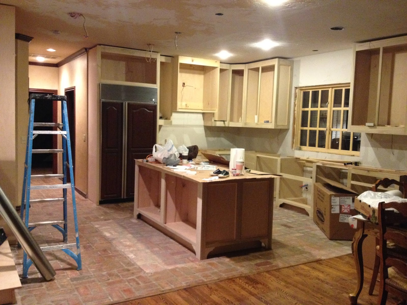 Upper kitchen cabinet height Lowered cabinets and yes, we have cardboard on the island. Remember