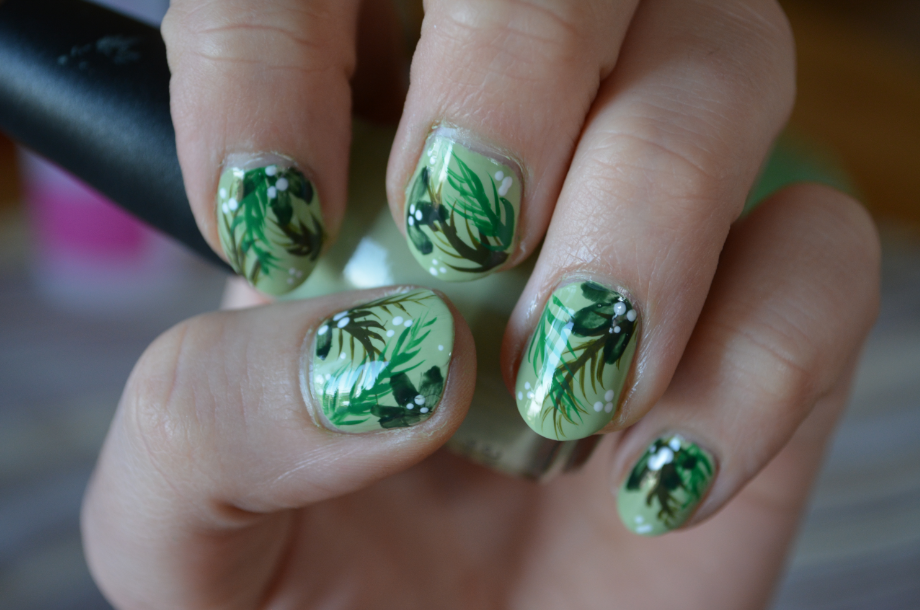 green nail design with four leaf clovers