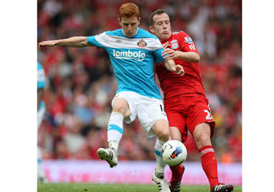 Liverpool's Charlie Adam tussles for possession with Sunderland's Jack Colback