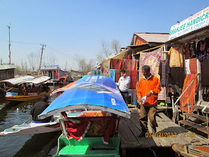 "Tourist Shikara boats" approaching the "FLOATING MARKET" on Dal Lake.