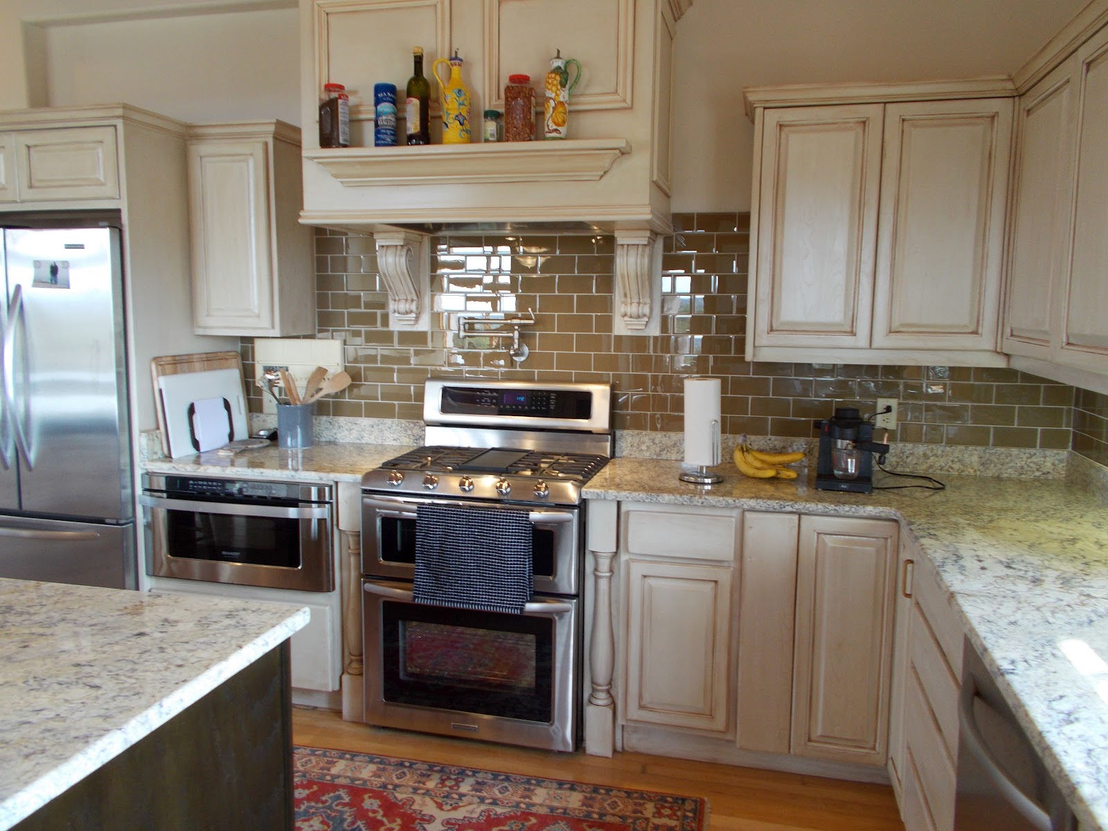 Black walnut kitchen cabinets White Kitchen Cabinets Brown Countertops with Backsplash