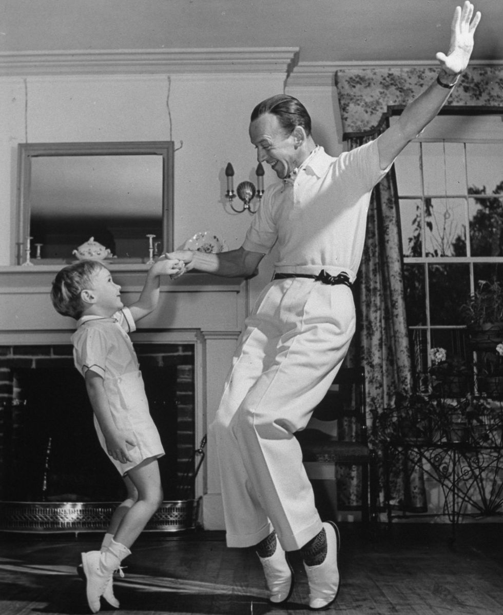 Fred Astaire teaching his son some moves at their home in 1940
