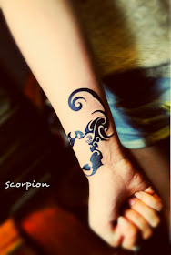 scorpion totem tattoo on the wrist