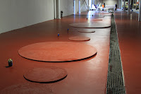 Construction and coating of pads to support chemical tanks.