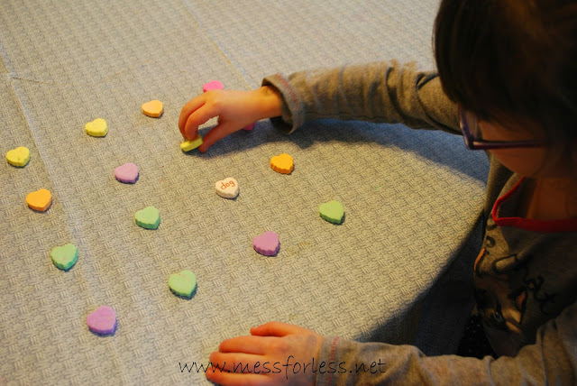 child playing with conversation hearts