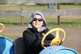 boy driving a blue cart