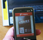 Image of QR code being scanned by a mobile phone.