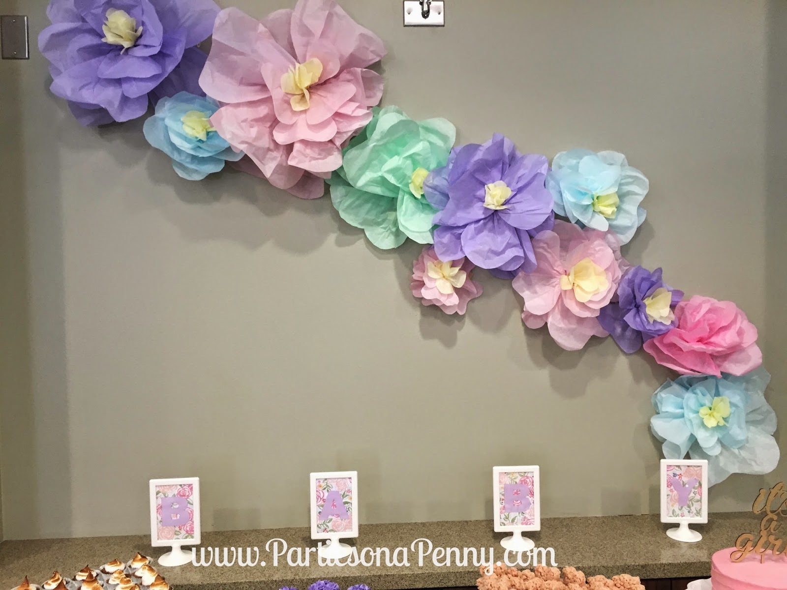parties on a penny spring themed baby shower paper flower backdrop dessert table