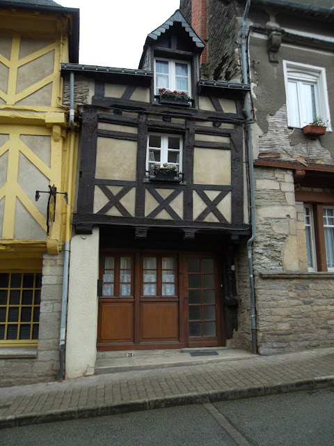 Little old half timbered house squeezed in between two bigger houses