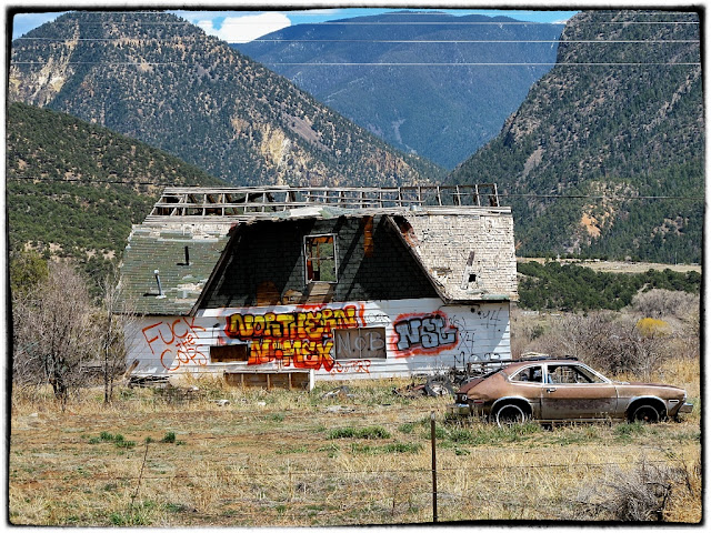  house near Taos,  'Fuck the cops' sprayed on it, opposite the police station.