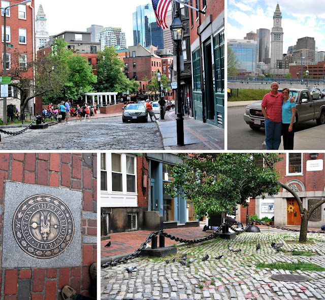 Four pictures of the North End of Boston. Looking south towards the rest of Boston from the square outside Paul Revere's home. Mom and Dad with a portion of the Boston skyline behind them. A seal marking Boston's Freedom Trail outside the Paul Revere house. Pigeons under a tree growing in the square outside the Paul Revere house.
