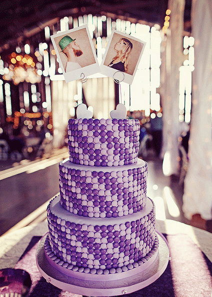 Stunning three tier round wedding cake with a purple candy covered spiral 