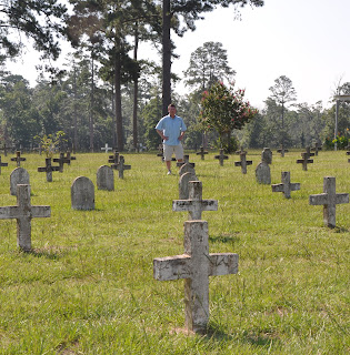 Dr. Frank Wilson stands among the headstones at the Captain Joe Byrd Cemetery.