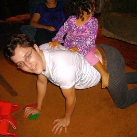 Photo of my husband giving a toddler a ride on his back
