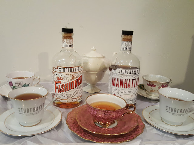 Studebaker cocktails with bottles and teacups