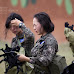 South Korean female soldiers wear gas masks to avoid smelling gas shells