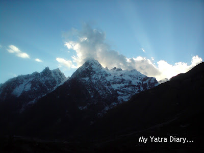 Snow clad mountainous peaks and clouds in the Mana Village near Badrinath in the Garhwal Himalayas in Uttarakhand