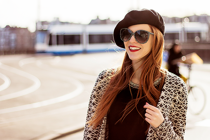 Retro fashion blogger outfit with a long aztec cardigan, beret, high waisted jeans and sheer striped socks