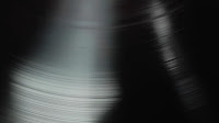 Close up of a spinning vinyl record.  Looks a little like an ultrasound