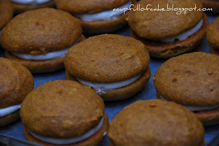 close up of white creme filled dark fluffy whoopie pies