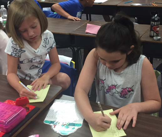 Two third graders work together on a division problem