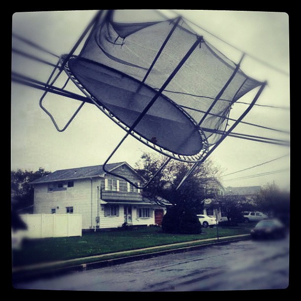 Hurricane Sandy hangs trampoline up in utility cables.