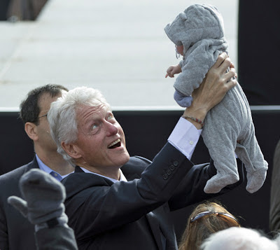 Bill Clinton smiles at baby