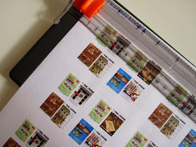 Sticker sheet printed with dolls house miniature versions of The tiny Times magazine, in a Fiskars cutter.