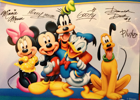 A postcard showing Mickey, Minnie, Donald, Goofy and Pluto