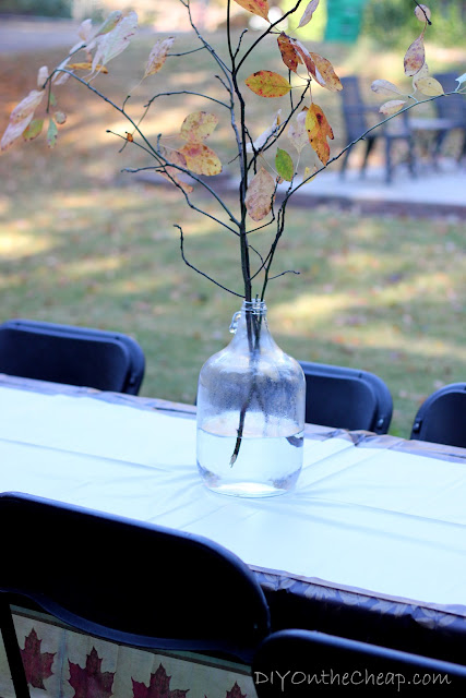 Old milk jug + tree branches = pretty Fall centerpiece