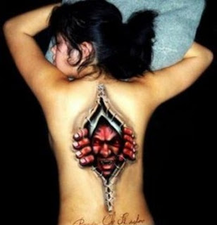 biomechanical tattoo on the back: monster inside the body