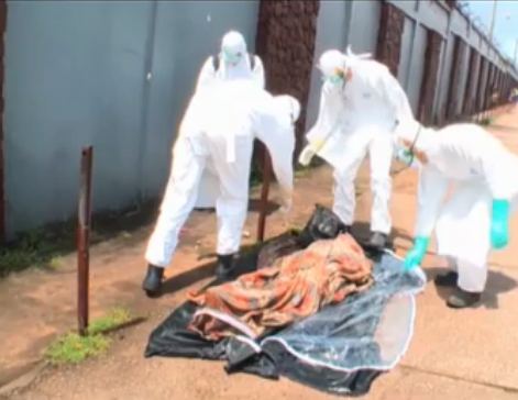Photo: See incredible moment funeral workers realise 'dead' Ebola victim is alive Photo: See incredible moment funeral workers realise 'dead' Ebola victim is alive