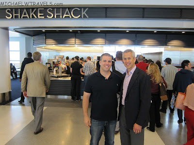 a group of men standing in front of a restaurant