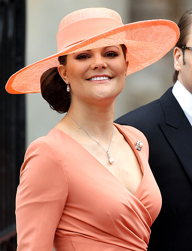 Her matching coral hat reminds Philip Treacy Lady Gaga Hats. Her matching coral hat reminds