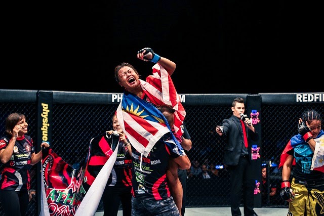 Ann Osman celebrates her hard-fought win against Ana Julaton. Ann Osman celebrates win against Ana Julaton in ONE FC 19 Reign of Champions
