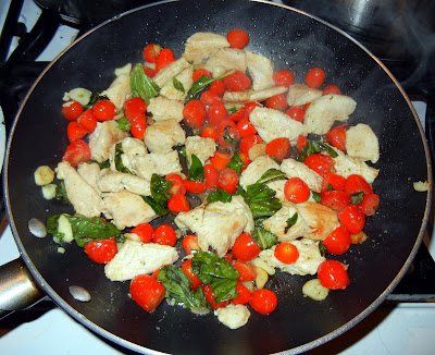 Garlic, basil and tomato chicken over spaghetti