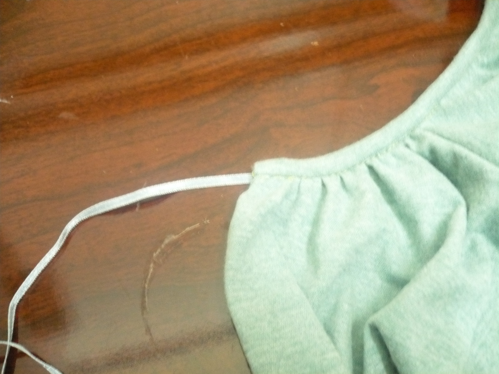 13. Now cut the ribbon into two parts and sew each of these to the ends