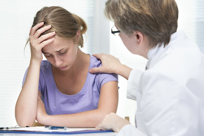 image of  a young women getting cousnel from a mental health professional