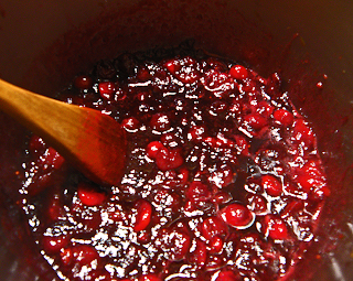 Hot Cranberry Sauce with Wooden Spoon Stirring