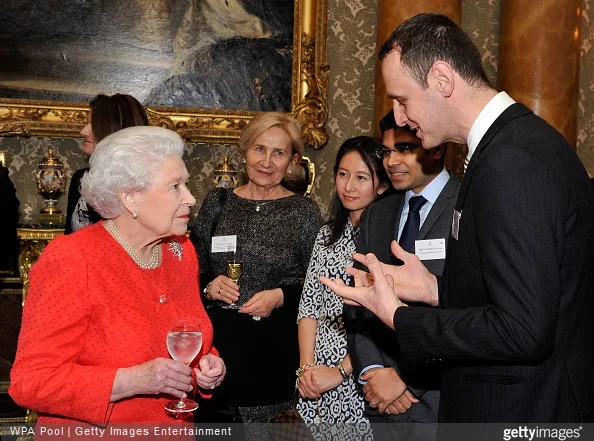 Queen Elizabeth II speaks with young lawyers and law students during a reception to mark the 800th anniversary of the Magna Carta at at Buckingham Place