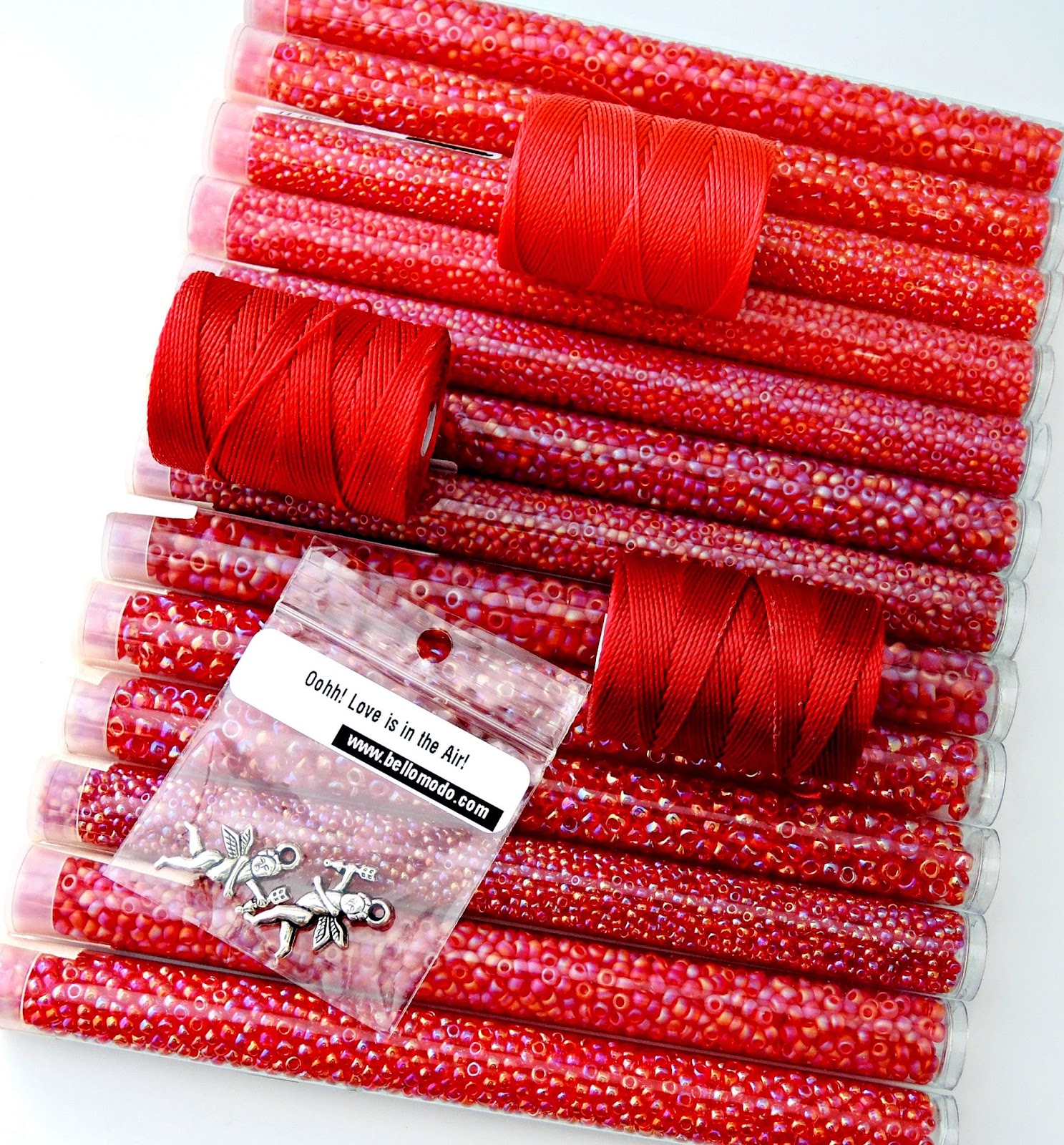 Selection of seed beads and bead cord in red.