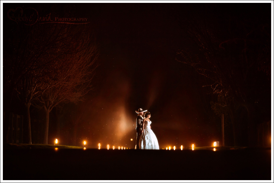 The long road night shot of bride and groom dramatic lighting
