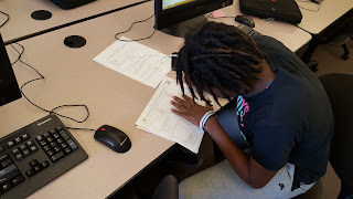 Ashanti is making adjustments to her storyboard before she heads out to film.