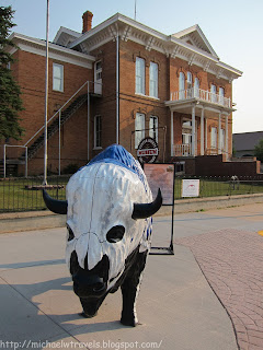 a statue of a bull in front of a building