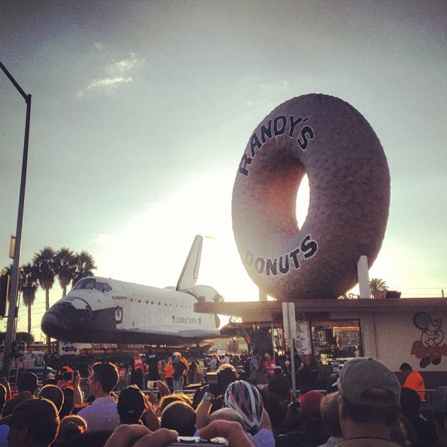 Space shuttle Endeavor passes an Iconic LA donut shop