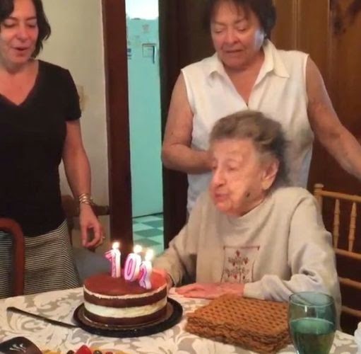 Aww! Adorable granny blows out her teeth as she tries to blow out her birthday candles
