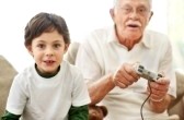 7715073-portrait-of-boy-and-his-grandfather-with-video-game-controllers-sitting-on-sofa--indoors.jpg