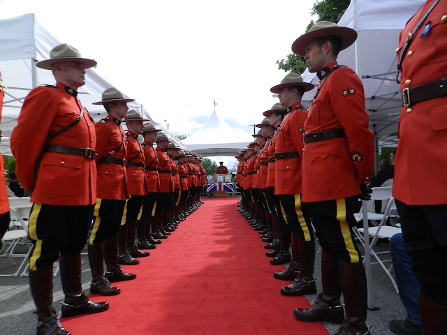 RCMP line the red carpet with the MC at the podium