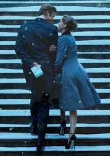 Video still of the couple on the snowy stairs